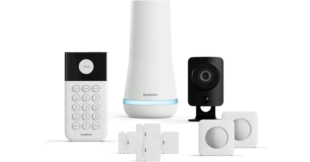 A white background displaying the core components of the SimpliSafe home security system: the tall, cylindrical Base Station, the white keypad, the black indoor camera, and a cluster of white Entry and Motion Sensors.