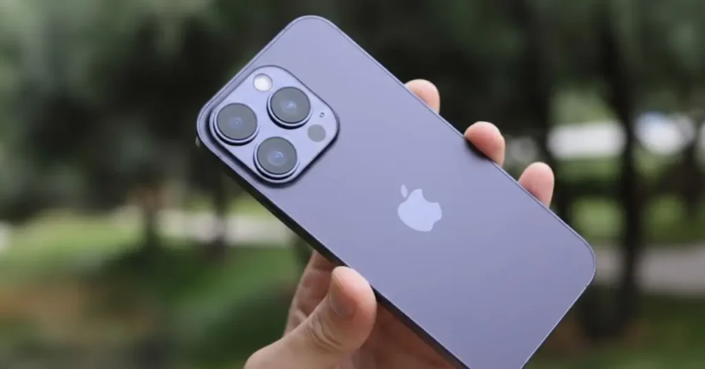 "A hand holding a leaked conceptual design of the iPhone 18 Pro in a Deep Purple titanium finish with a triple-lens camera array."