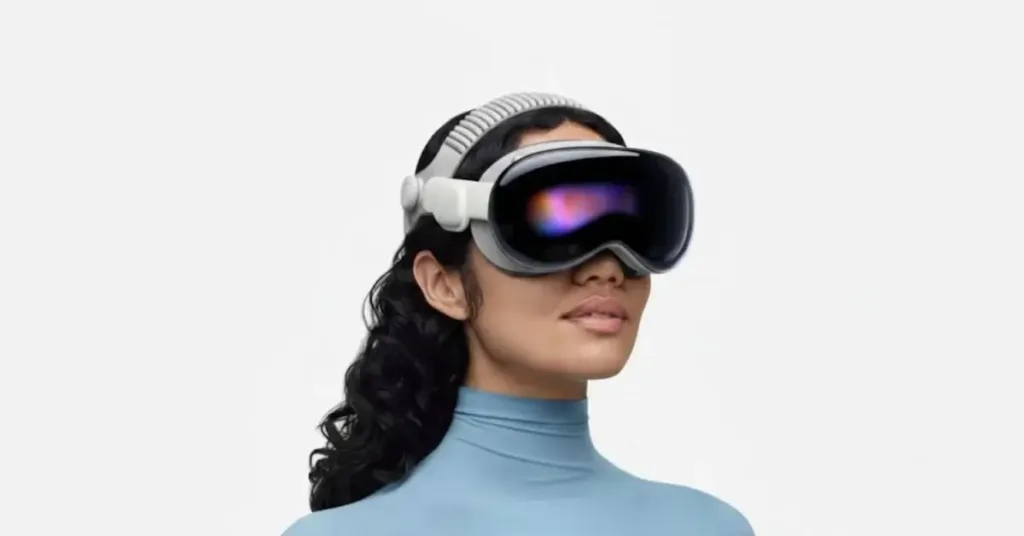 A woman wearing an Apple Vision Pro headset against a clean white background, showcasing the device's sleek design and external display.